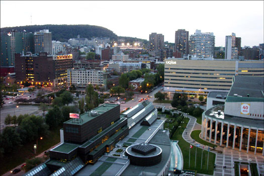 Twilight view from our eleventh-floor suite at the Wyndham Montreal, showing the Place Des Arts in the forground and part of Mont Royal on the horizon.