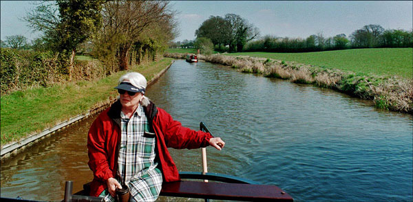 Narrowboat. Paula takes the helm on a sunny day