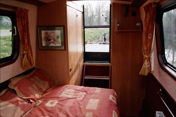 Narrowboat. Looking aft from the bedroom. Wardrobe on the left.